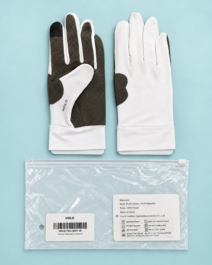 Both HOLD gloves laid flat beside the resealable bag they ship in, with the care and size label visible.