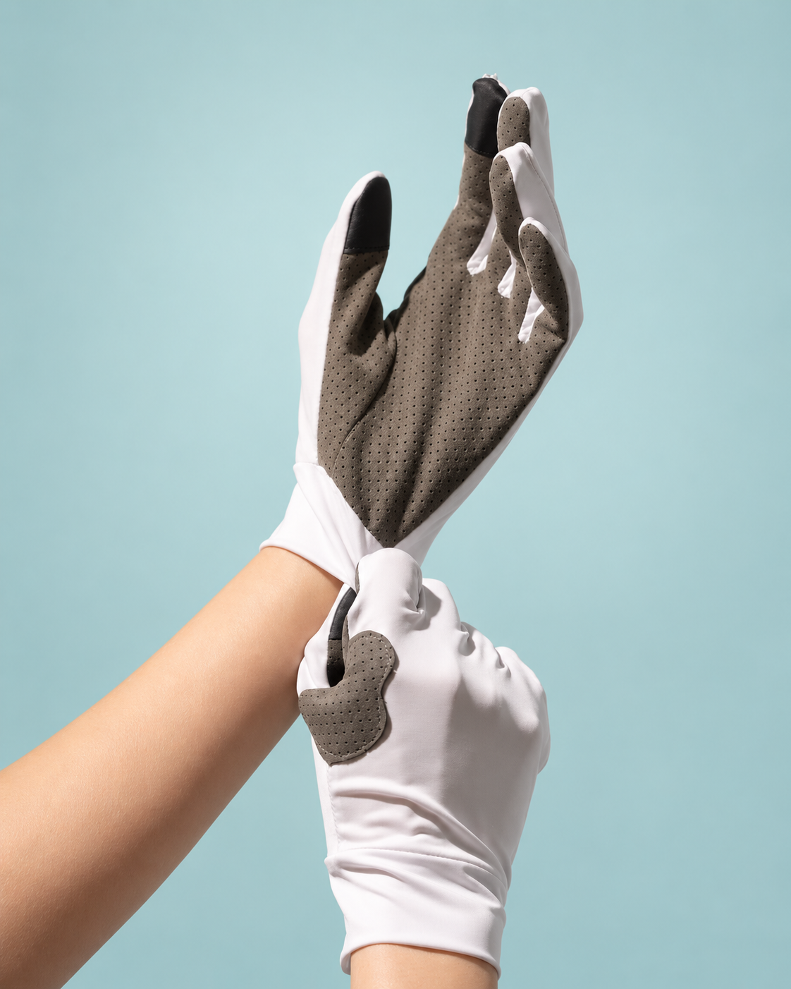 Pulling a HOLD glove on and settling the cuff at the wrist.